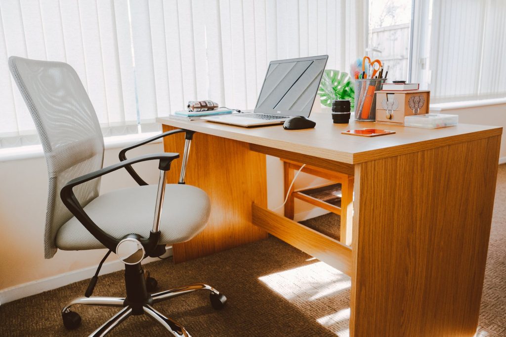 Image of an office with a gray chair and laptop